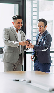 Colleagues looking at phone